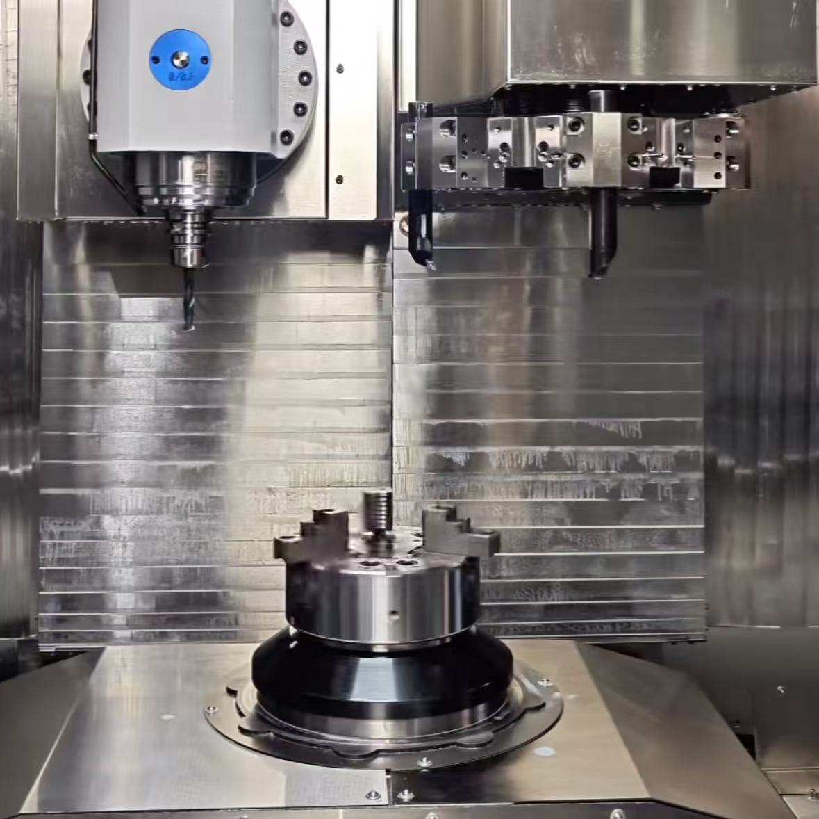 Multi-axis CNC machining center processing brass components with coolant system