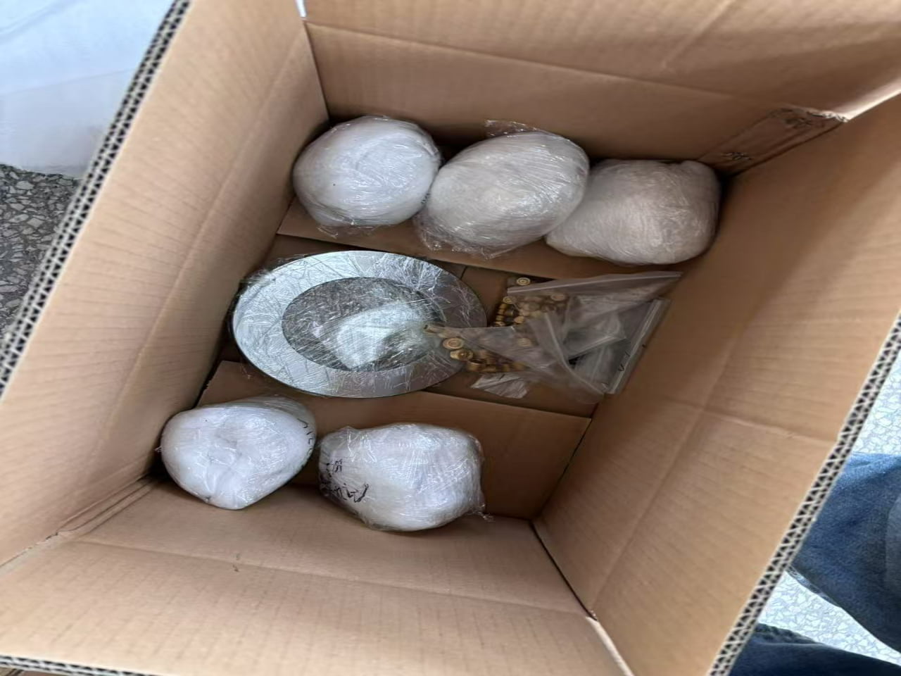 Custom foam inserts protecting CNC machined metal parts in export packaging