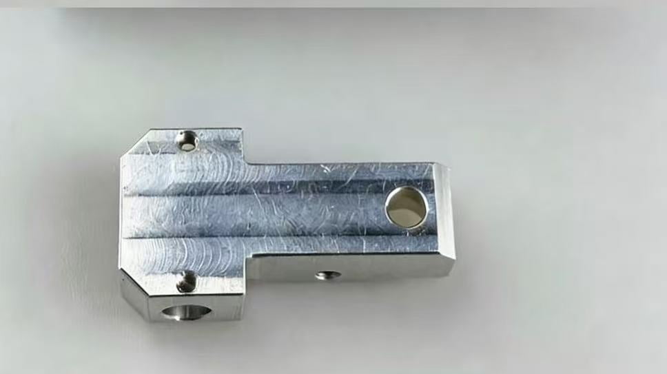 Metal surface showing CNC machining tool marks before bead blasting